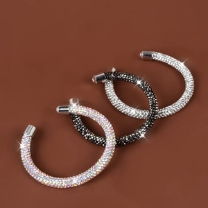Detailed view of shimmering crystal teardrop bracelets in silver, black, and rainbow colors