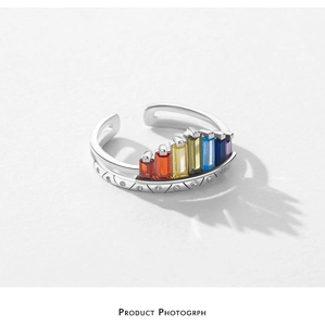 Macro shot of silver crown ring with seven colorful rainbow stones and beaded detailing
