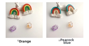 Handmade woven rainbow keychain charms in orange and peacock blue with cotton tassels
