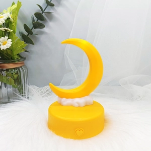 Detailed view of moon and cloud night light on yellow base with heart switch