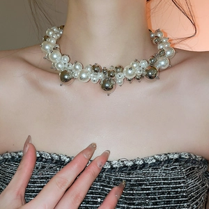 Detail view of French irregular beaded pearl and silver metallic sphere necklace