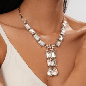 Detailed view of silver chunky chain necklace with crystal pendants and HE letters