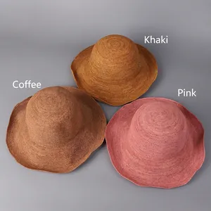 Handmade woven raffia sun hats in khaki, brown and pink with wide wavy brims