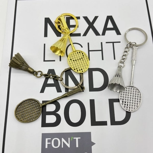 Detailed close-up of metallic badminton racket and shuttlecock keychains in three colors