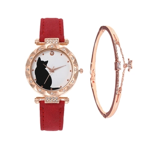 Close-up of women's red quartz watch with cat motif dial and rose gold star charm bracelet
