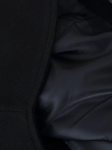 Detail of premium black wool fabric and smooth inner lining on hooded coat