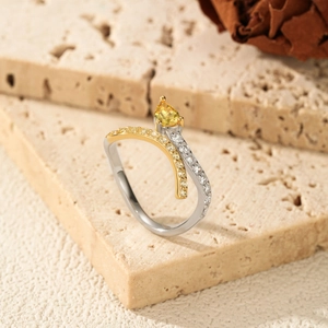 Elegant silver snake ring with yellow pear-cut gemstone and pave diamonds on stone base