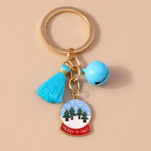 Close-up of Christmas keychain with blue tassel, bell, and a festive snow globe charm