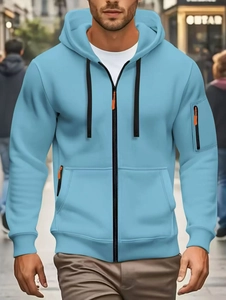 Detail of sky blue hoodie with black zipper and vibrant orange accents on the pockets