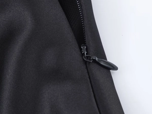 Macro view of a durable invisible black zipper on silk texture scarf dress fabric