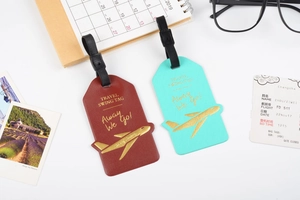 Detail of PU leather luggage tags with gold airplane stamping and adjustable straps