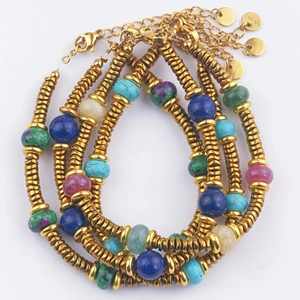 Detail of colorful gemstone beaded bracelet set with gold stainless steel spacers