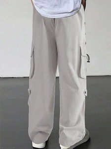 Detailed view of grey techwear parachute pants with functional side cargo pockets