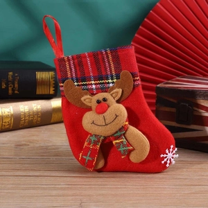 Detail of red Christmas stocking featuring 3D reindeer decor and plaid cuff hanging decor