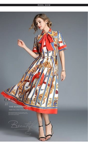 Close-up of vintage baroque floral print dress with a red bow and striped satin fabric