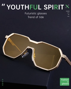 Close-up of gold geometric frame and amber lenses on futuristic punk sunglasses