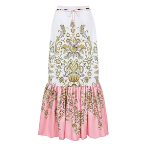 Detail of bohemian floral maxi skirt with beaded waist tie and ruffled patchwork hemline