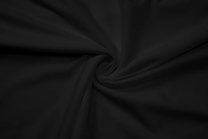 Close-up of ruched black fabric detail showing soft texture and smooth material drape
