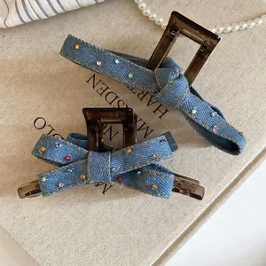 Denim blue fabric and rhinestone hair claw clips set on vintage book background