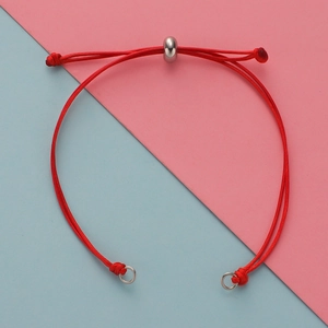 Macro shot of red braided cord bracelet with adjustable slide knot and steel beads