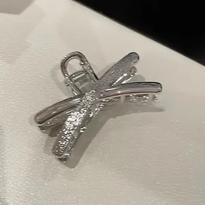 Detailed view of silver liquid metal butterfly hair claw clip with glitter finish