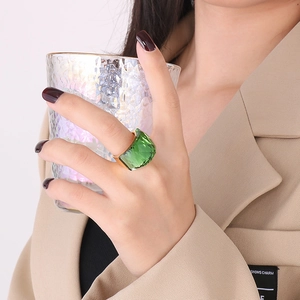 Close-up of a 18K gold plated ring with a large faceted emerald green crystal stone