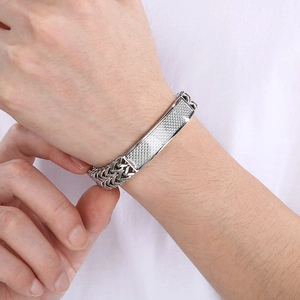 Detail of hip-hop silver titanium steel bracelet with textured plate and magnetic clasp
