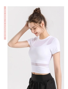 Close-up of white cropped sports top featuring breathable mesh panels and round neck design