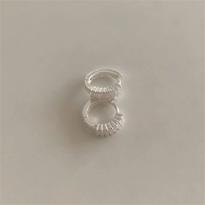 Detail view of silver 925 huggie earrings with a row of sparkling baguette-cut zircons