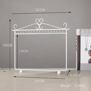 White iron necklace display rack with heart design and 18 hooks for jewelry storage