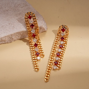 Detail of 18k gold plated tassel earrings with red and white cubic zirconia accents