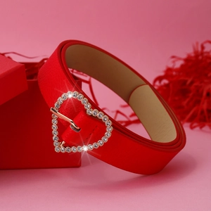 Red heart buckle belt with rhinestones and matching gift box on a pink background