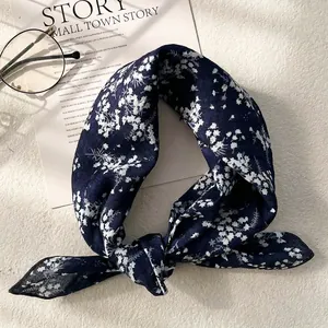 Detail shot of navy blue floral cotton linen scarf with vintage pattern and glasses