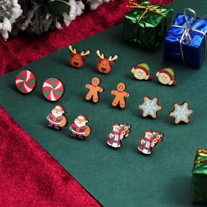 Close-up of wooden Christmas stud earrings featuring Santa, reindeer, and gingerbread men
