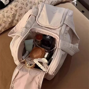 Macro detail of spacious interior with side pockets in beige quilted vanity bag