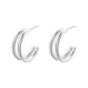 Detail of silver double-layered C-shaped stud earrings with a sleek metallic finish