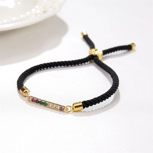 Adjustable black rope bracelet with a gold bar set with multi-colored cubic zirconia