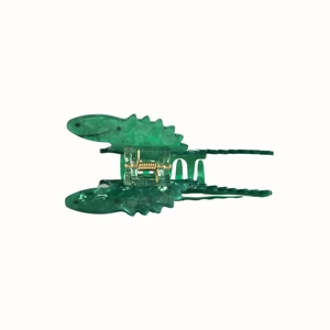 Detail of green dinosaur acetate hair claw clip showing a transparent spring mechanism