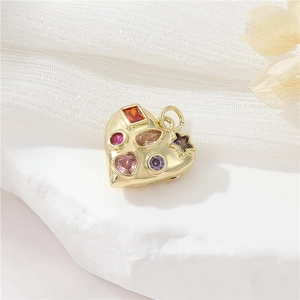 Macro view of gold heart pendant featuring colorful zirconia and teardrop gems