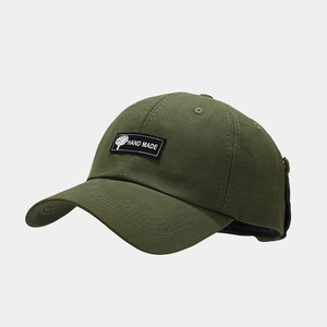 Detail of army green canvas baseball cap with black handmade patch and triple stitched brim