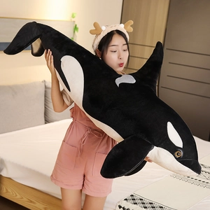 Large plush orca whale toy held by a model to showcase the 120cm oversized soft design