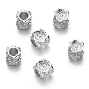 Macro detail of silver flower-shaped CCB loose beads with central hole for DIY jewelry making
