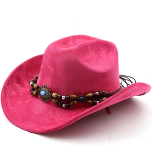 Detail of bohemian pink suede cowboy hat with turquoise and beaded ethnic band