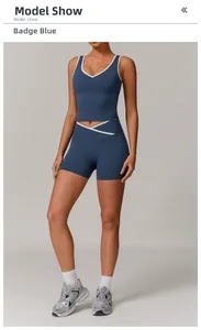 Detail view of high-waist yoga set in badge blue with white trim and crisscross waist