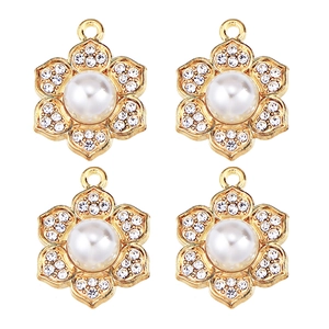Detail of four golden flower pendants featuring center pearls and sparkling zircons