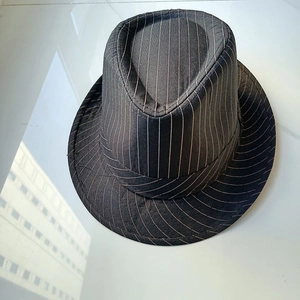 Detailed top view of a classic black Fedora hat with elegant white vertical pinstripes