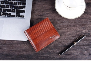 Close-up of brown wood texture wallet on a desk with laptop and coffee cup