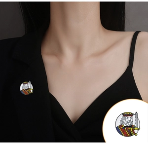 Close-up of King of Hearts enamel brooch on a black suit with detailed inset view