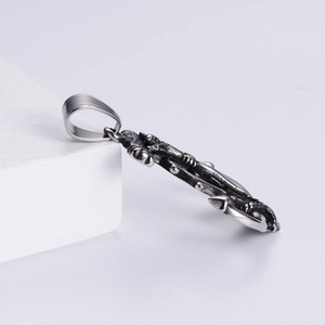 Macro side view of vintage nautical anchor pendant showing 3D texture and metallic finish