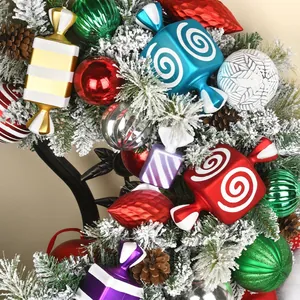 Festive Christmas wreath with colorful candy ornaments, striped baubles and pine cones